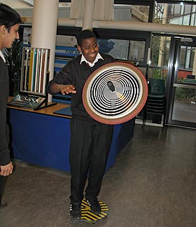 A boy investigates the effects of the Gyrowheel exhibit during a school visit
